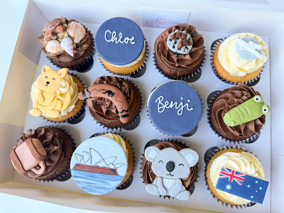 Box of personalised cupcakes with fondant toppers of a koala, the Sydney Opera House and the Australian flag